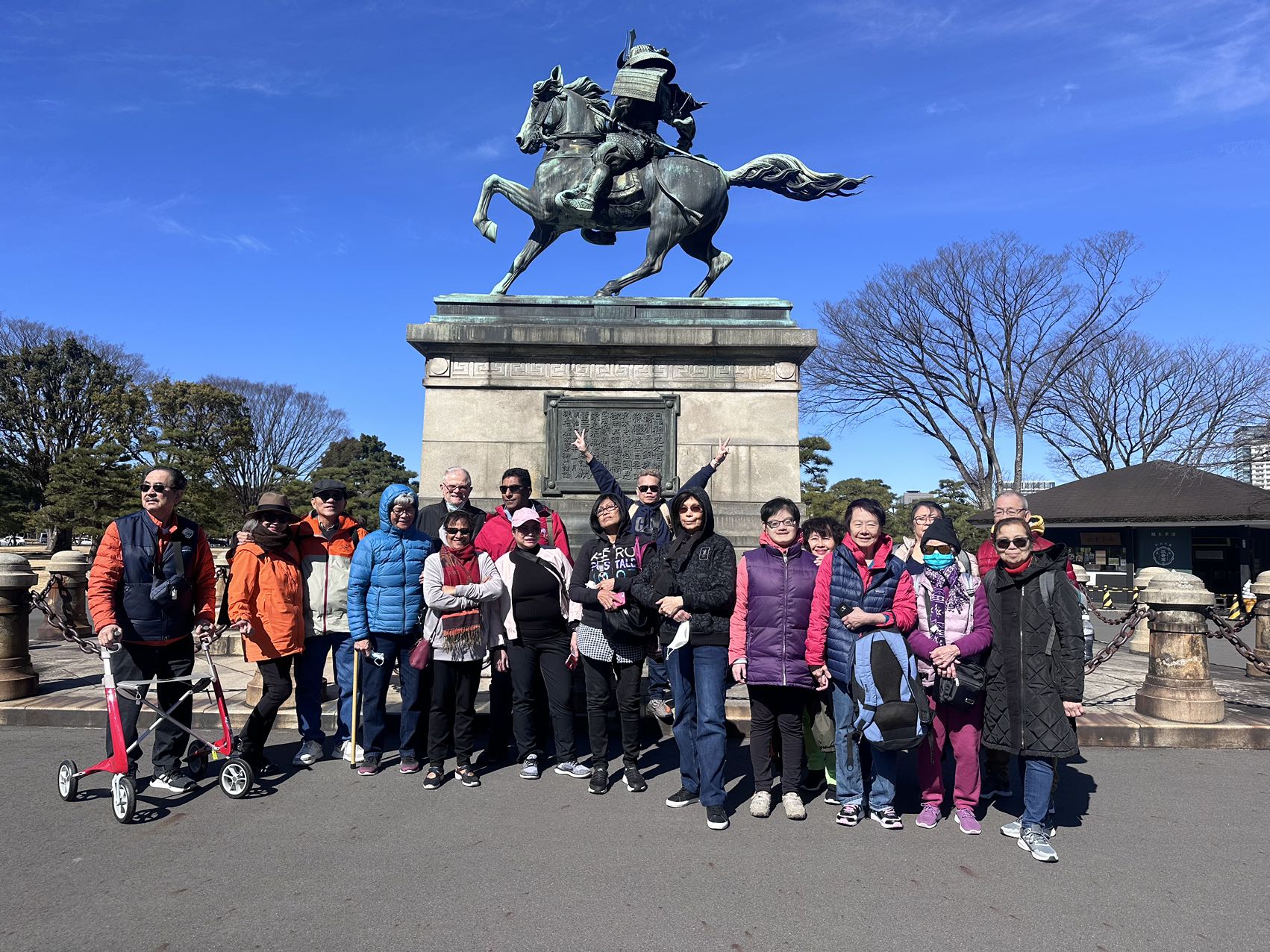 Guests gathered beneath an equestrian monument