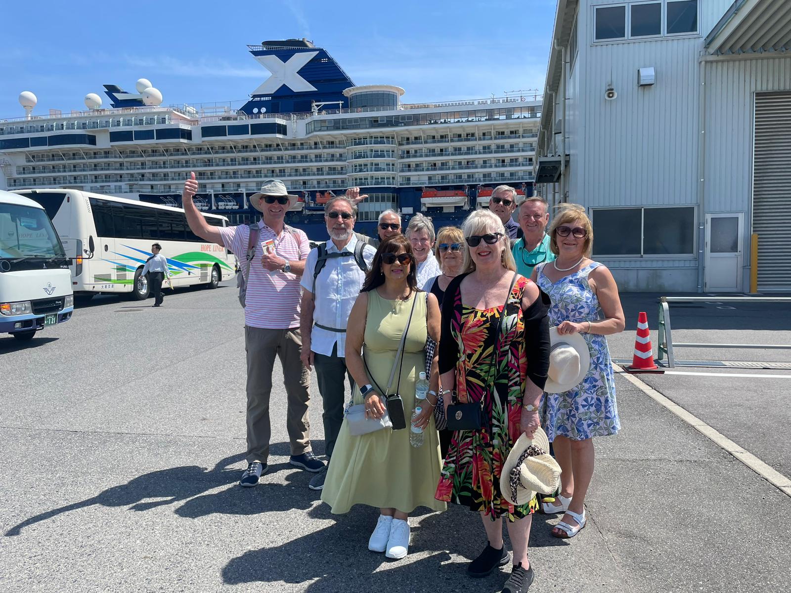 Cruise guests beside their ship at the port