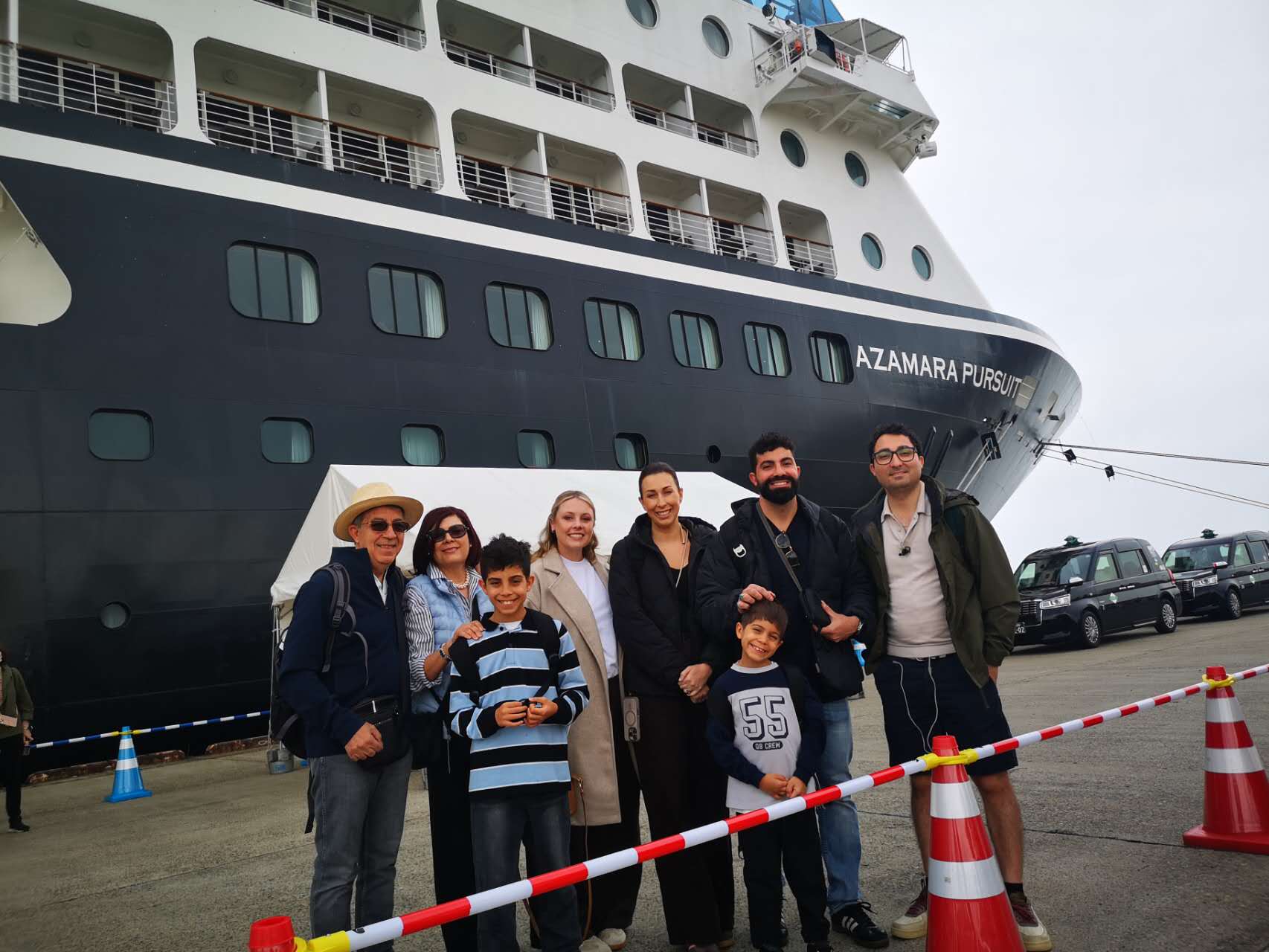 A family posing at the bow of Azamara Pursuit